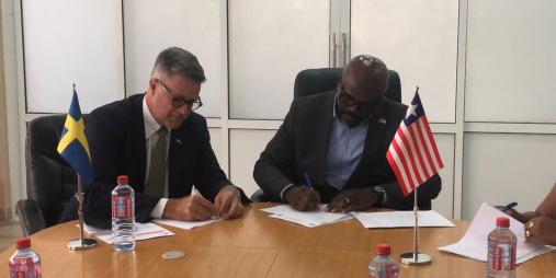 Swedish Ambassador H.E. Urban Sjostrom and Minister Giddings Signing the Agreement.